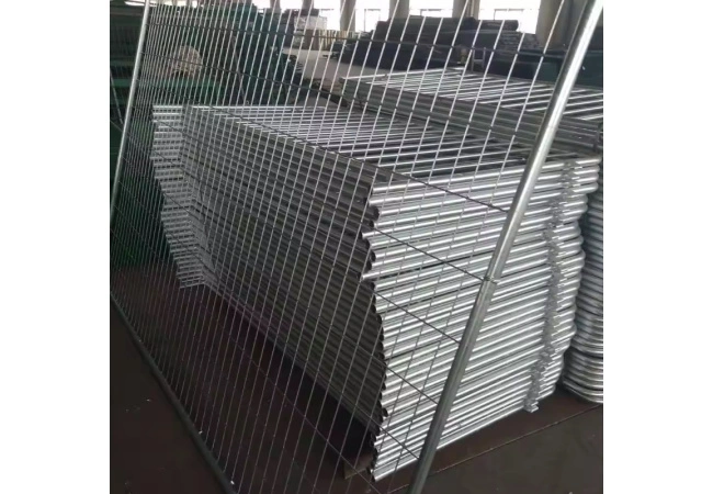 Stacked temporary fence panels in warehouse ready for construction site shipment